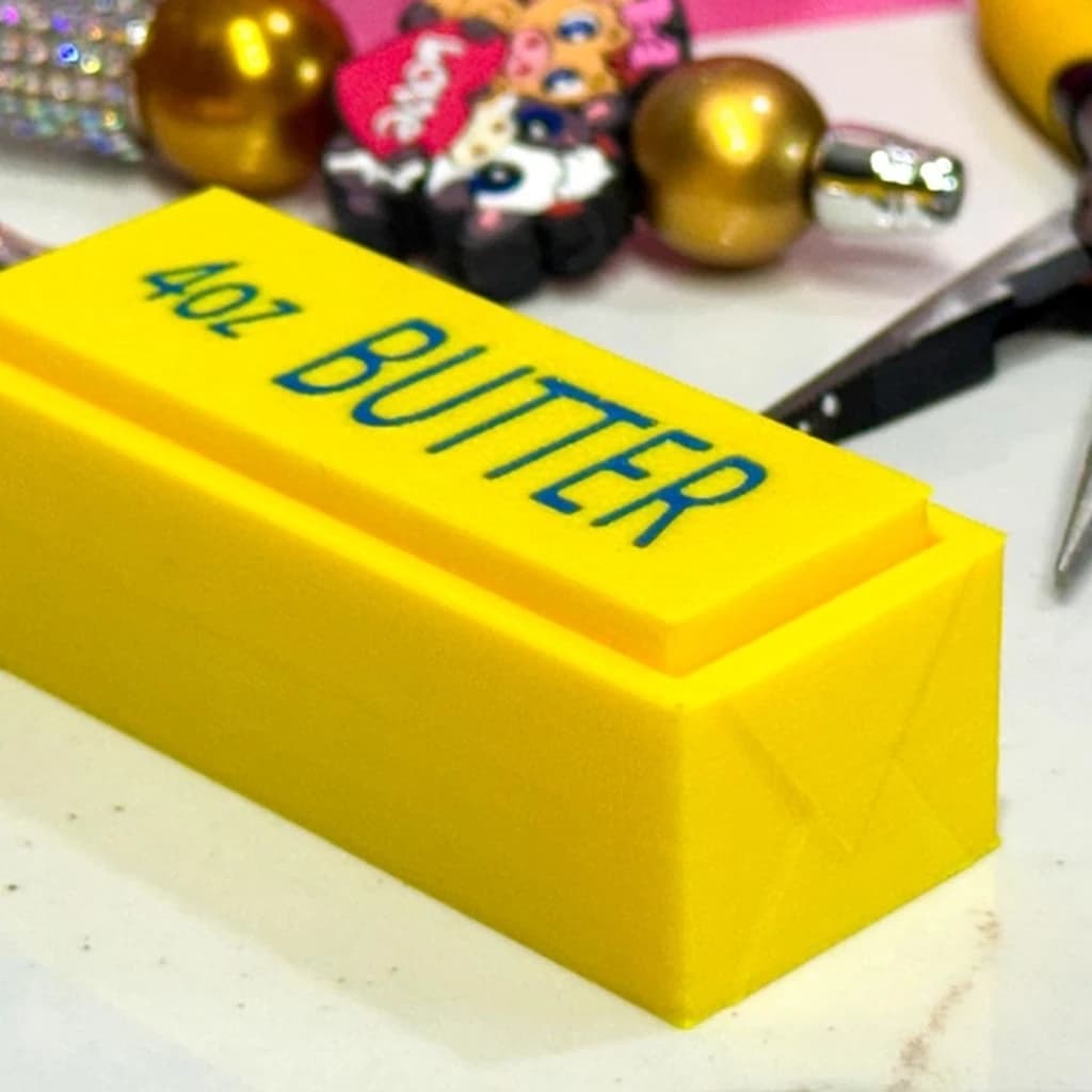 Butter Clicker close-up showing the yellow 4oz butter design.